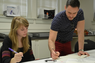 Brian Taylor works with a student on her design
